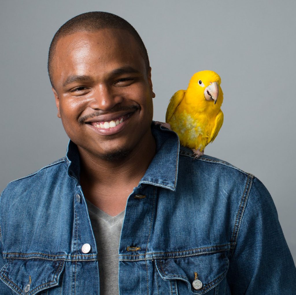 Man with yellow bird on shoulder