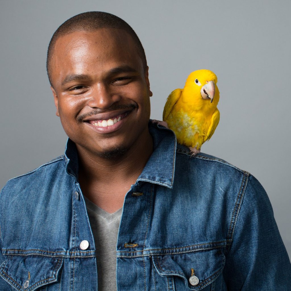 Man with yellow bird on shoulder