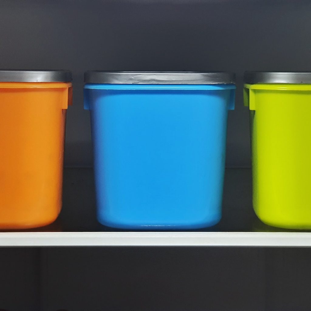 three colorful food storage containers