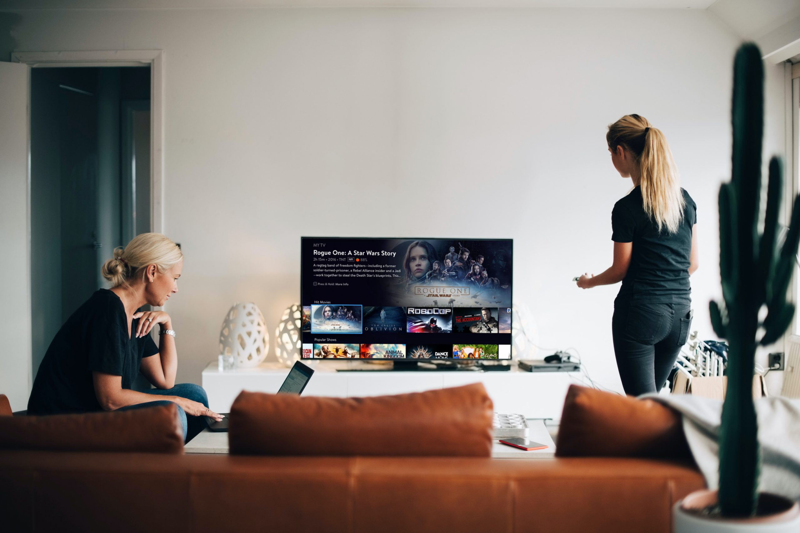 Two women watching TV in a living room