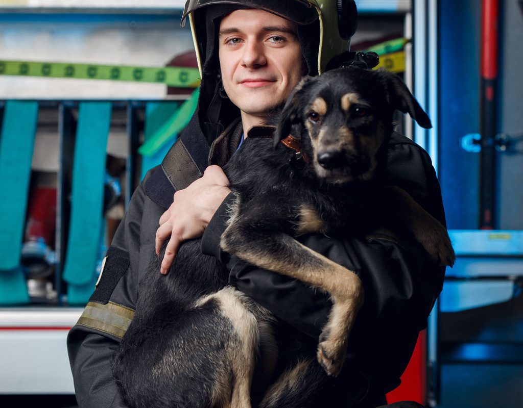 Firefighter rescuing dog.