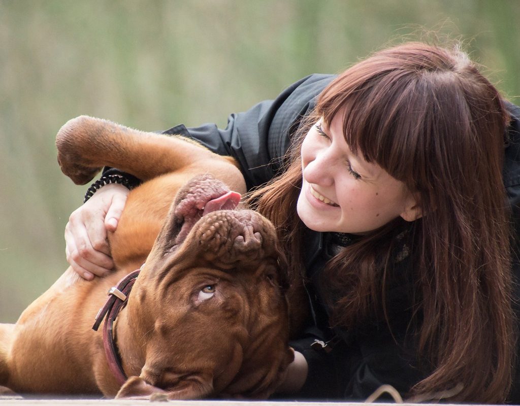 woman playing with dog