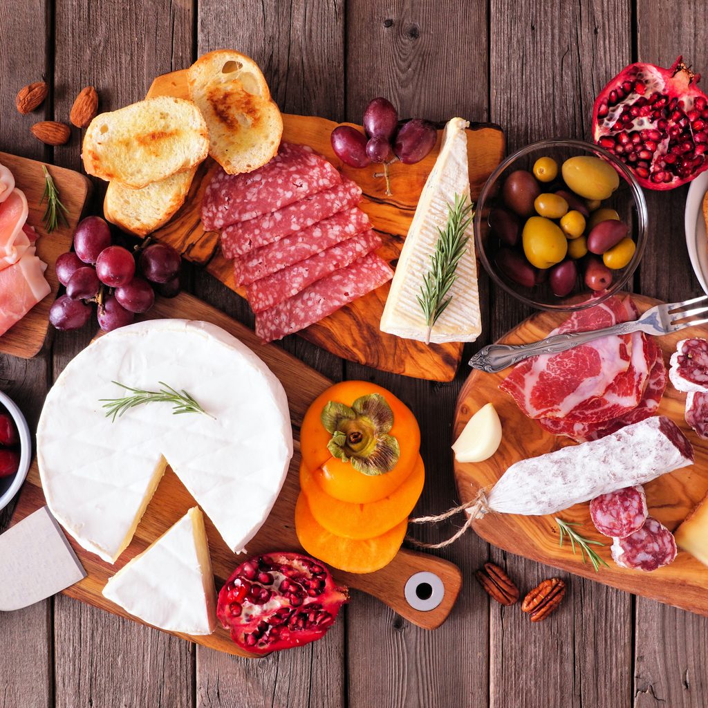 a charcuterie board of meats, cheeses, and fruits