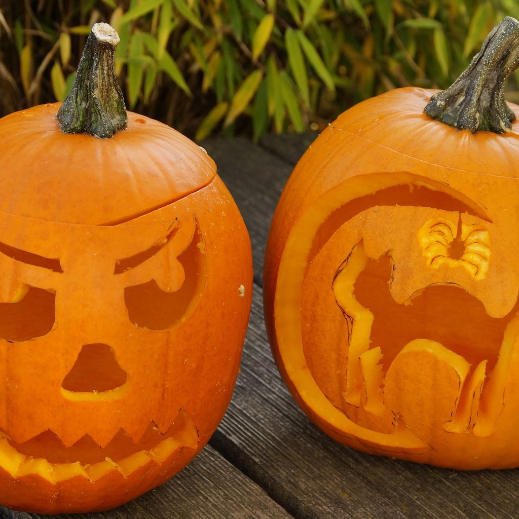 Jack o lanterns with a face and cat carving