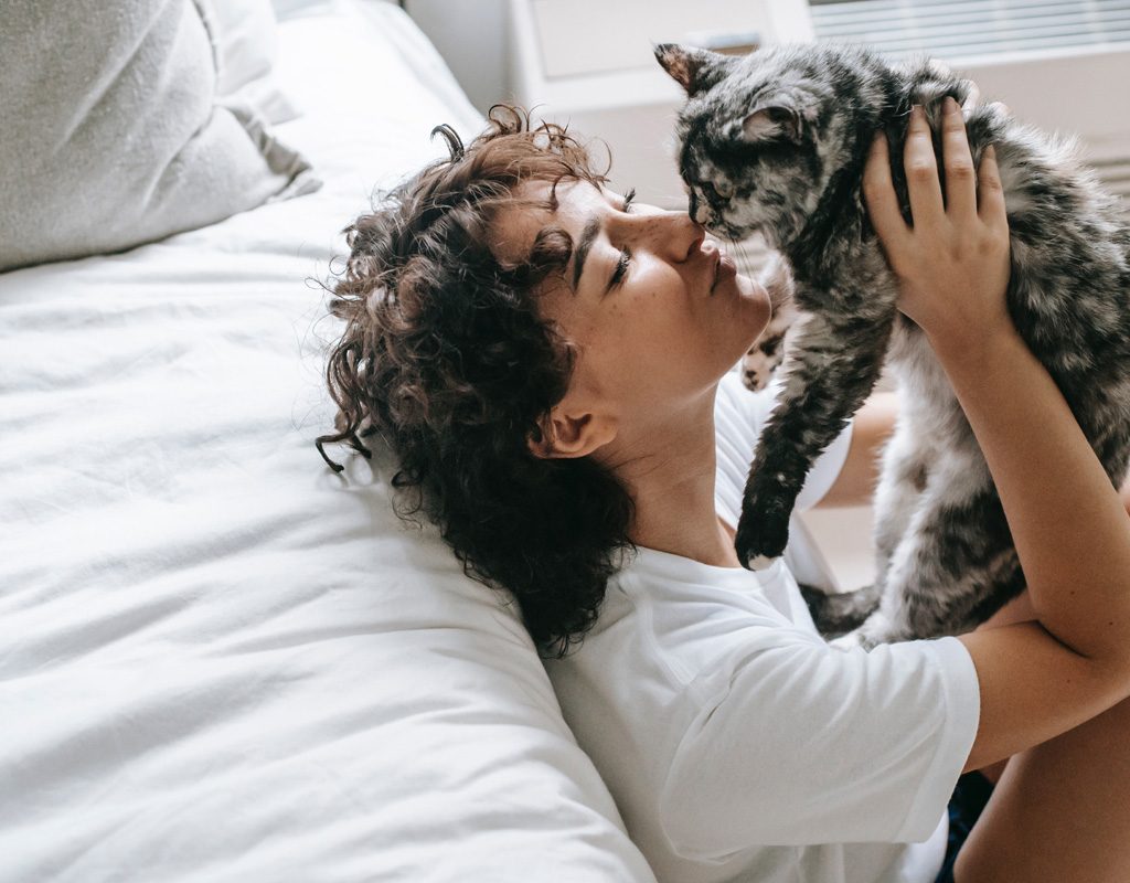 Woman kissing her cat