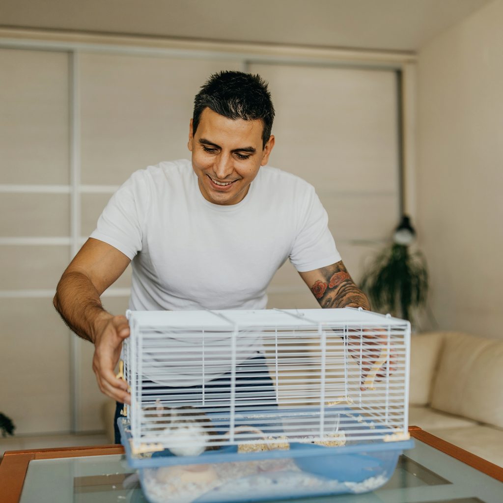 Man takes apart his hamster cage for cleaning