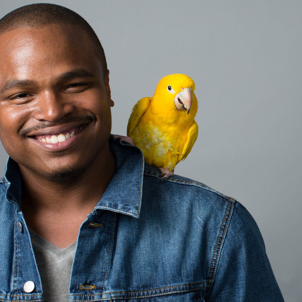 Man with yellow bird on shoulder