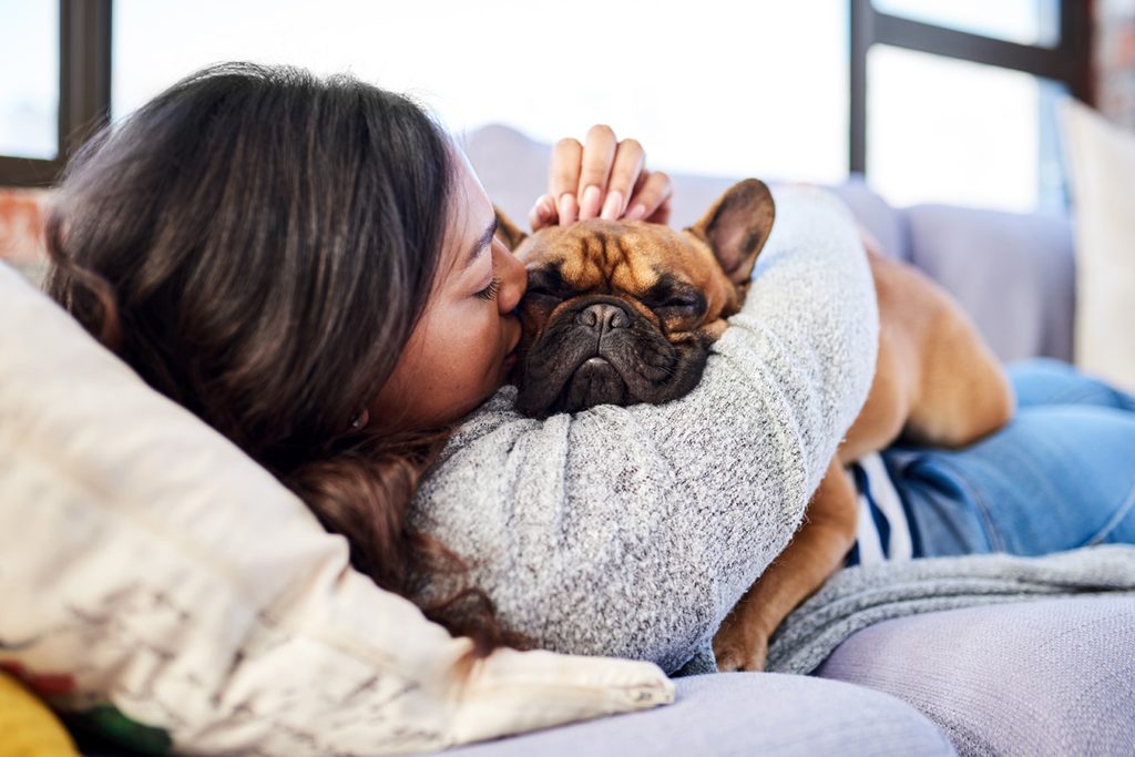 Woman cuddling with her dog.