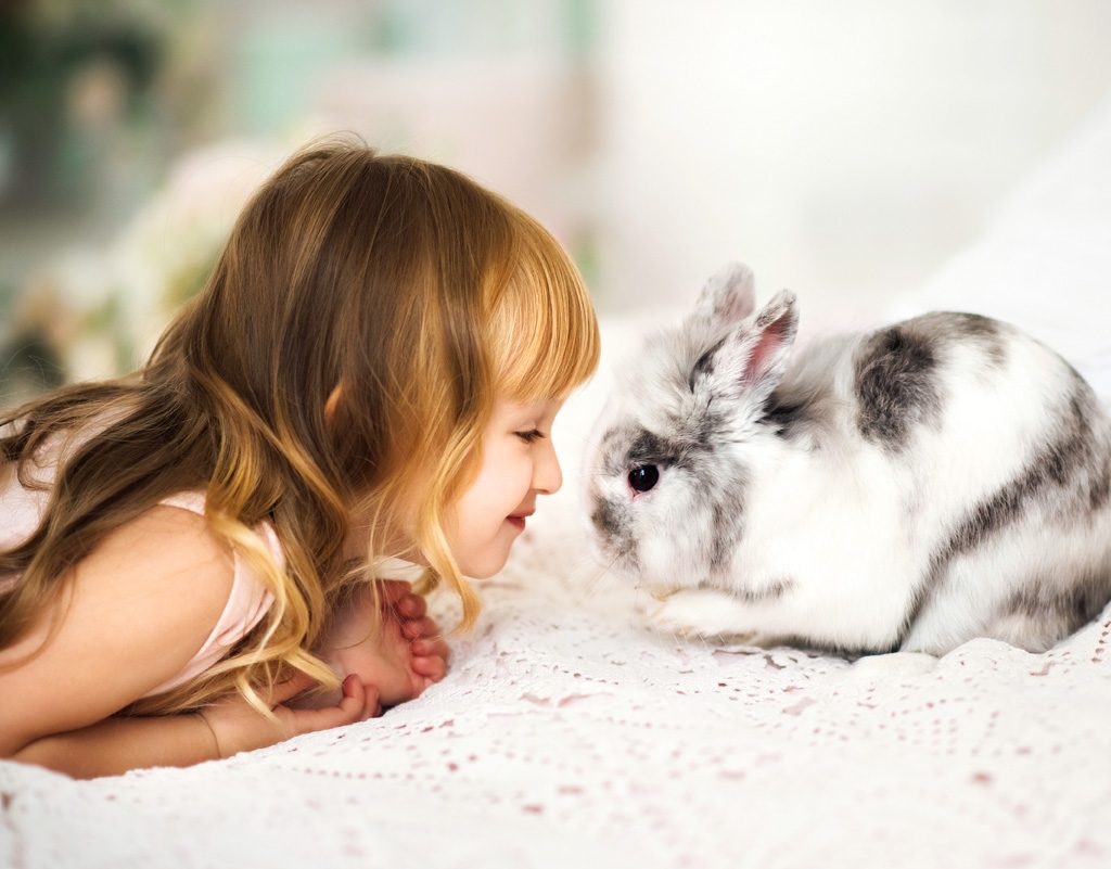Young girl with pet rabbit.