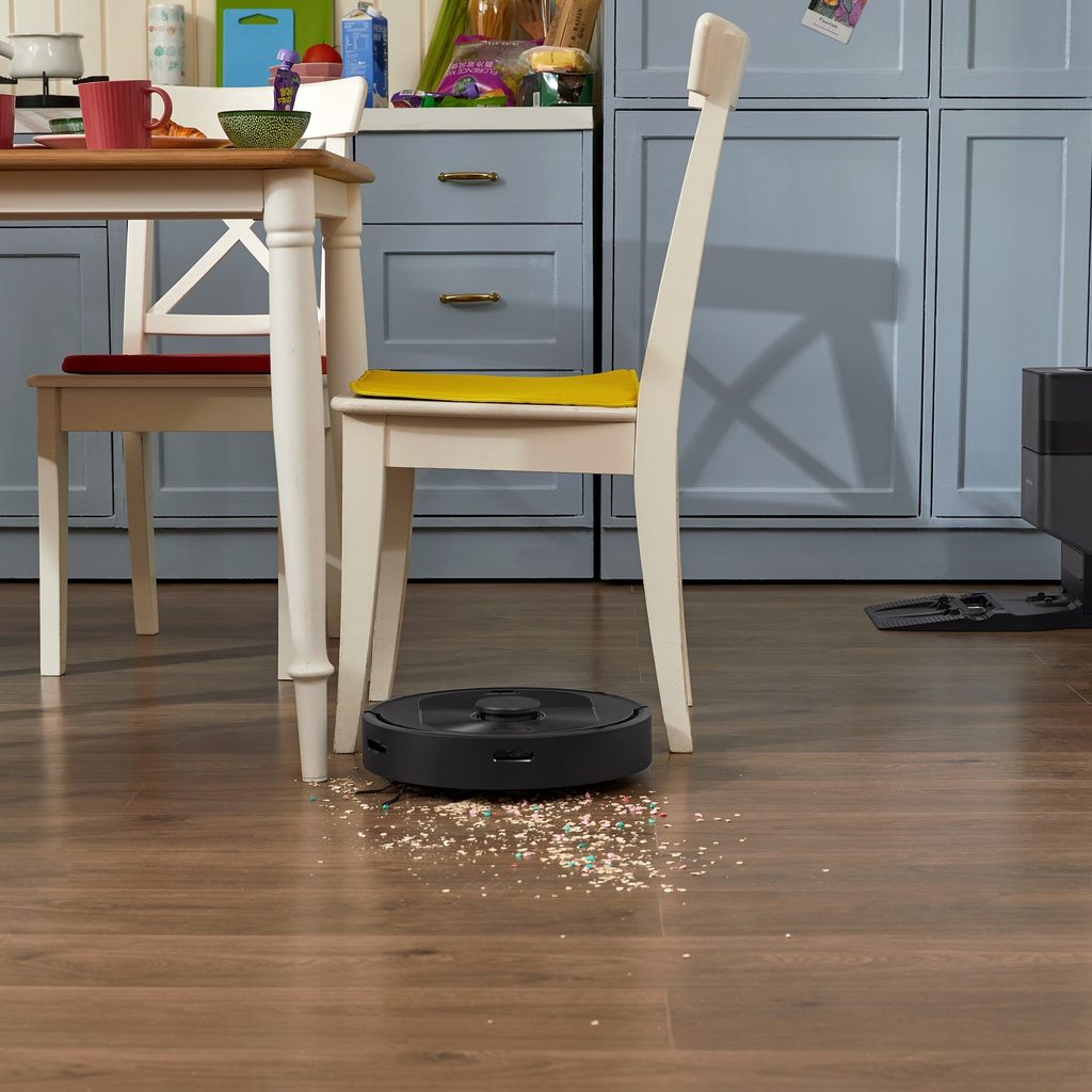 Roborock Q5+ robot vacuum auto cleaning a cereal spill.