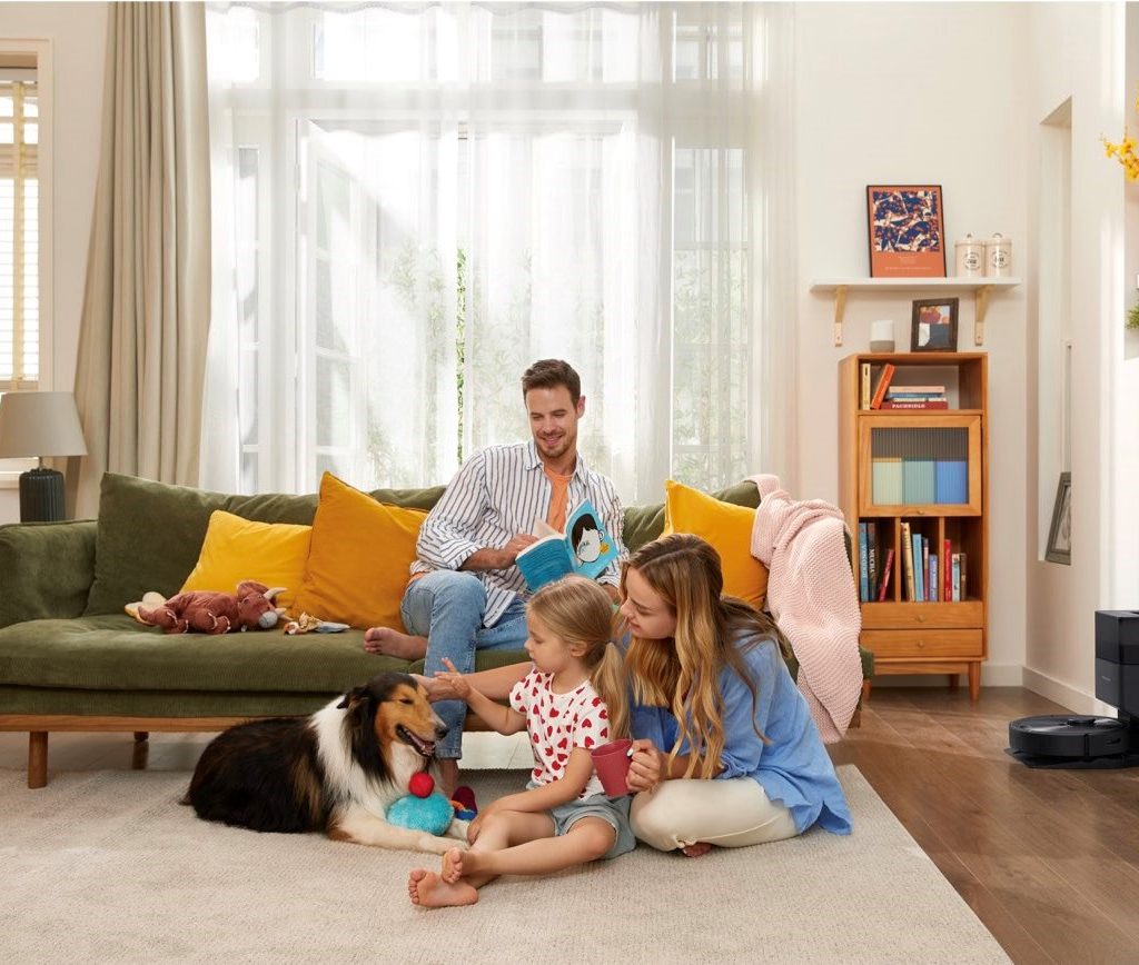Roborock Q5+ robot vacuum charging during family time.