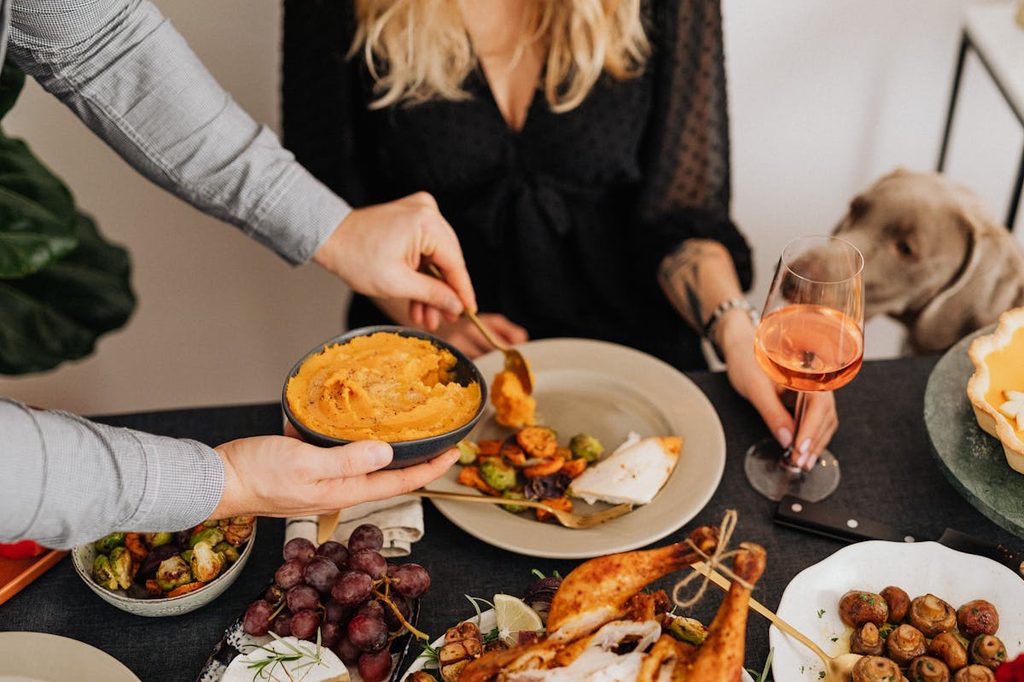 a dog standing near a thanksgiving holiday table