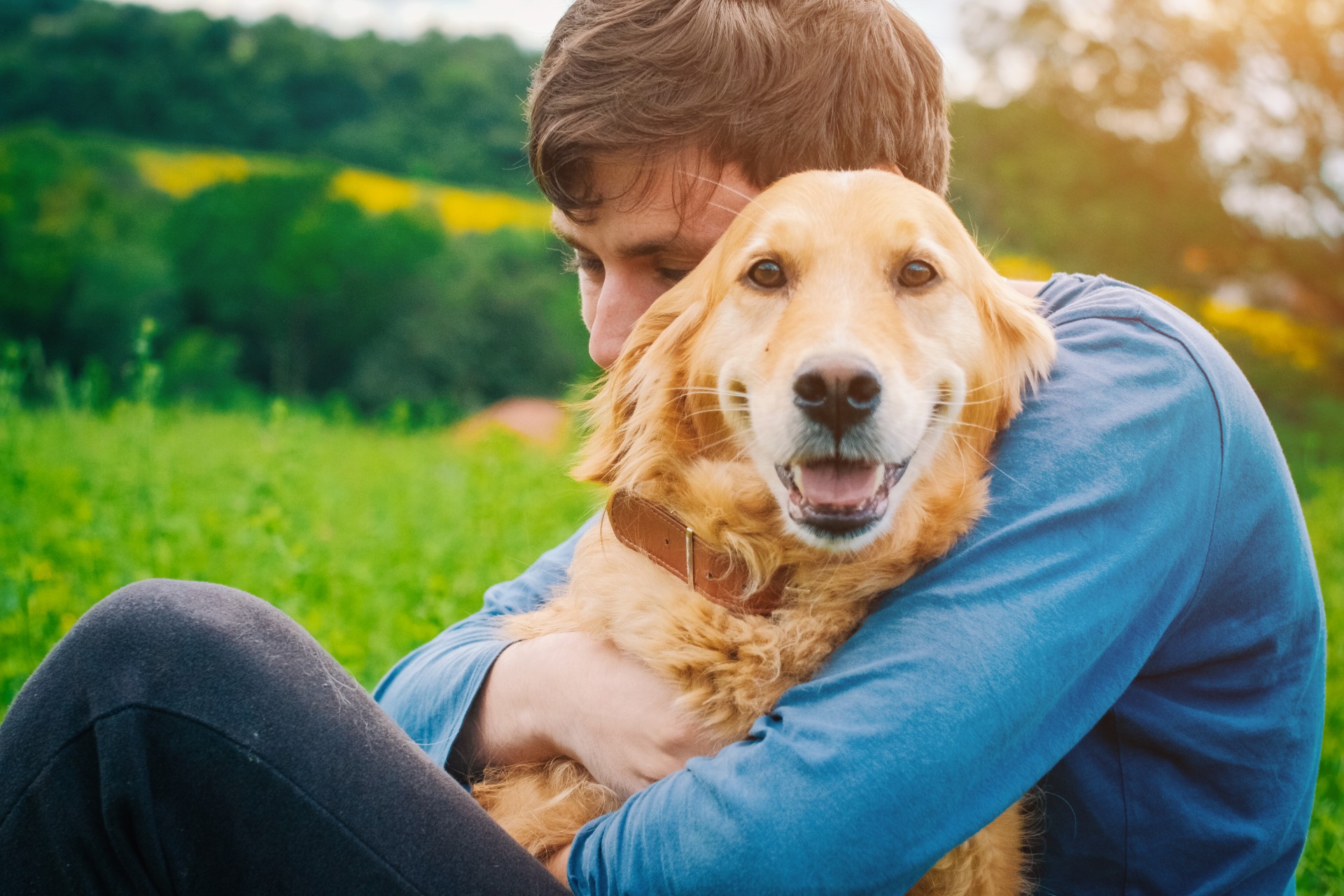 Man hugging golden retriever