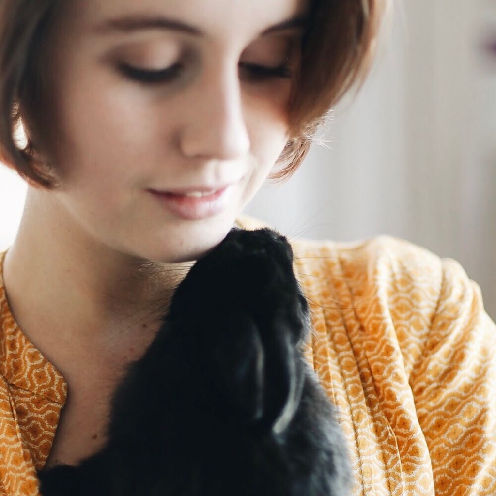 Woman holding black rabbit