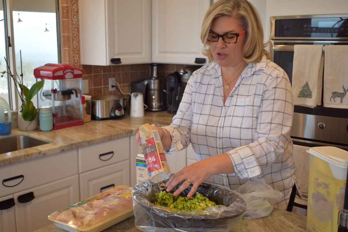 woman filling crock pot