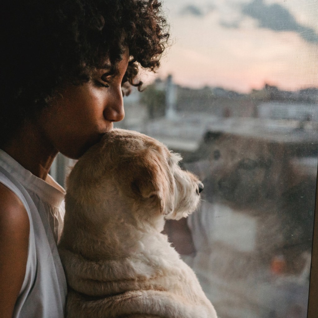 Woman kissing dog