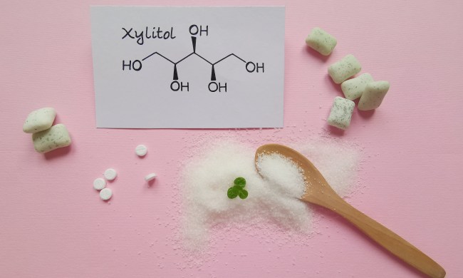 Xylitol with a wooden spoon and chemical structure