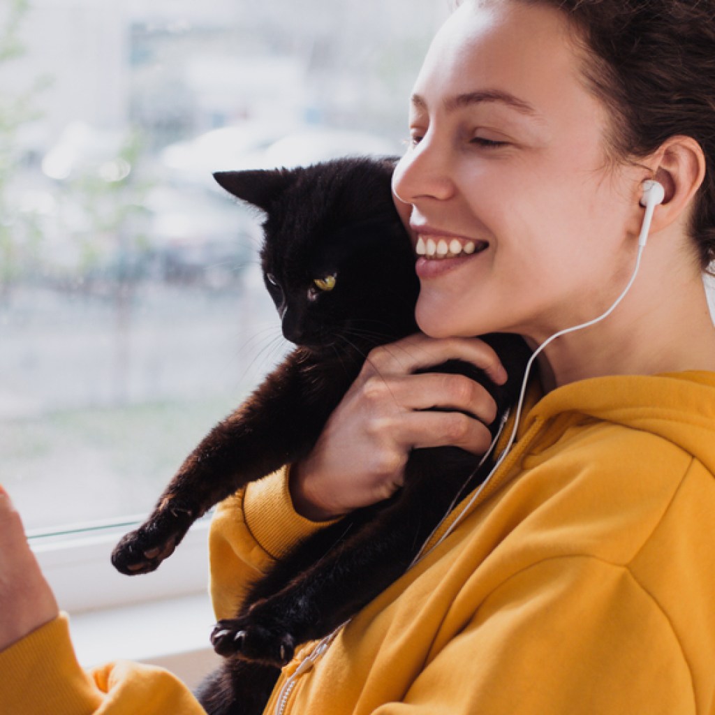 happy woman with black cat