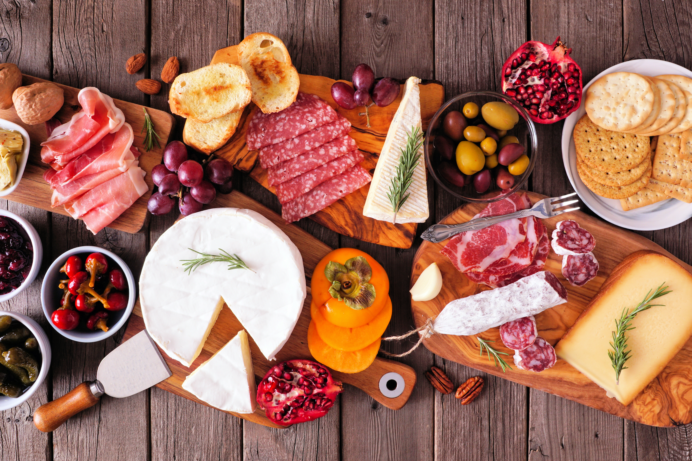 a charcuterie board of meats, cheeses, and fruits