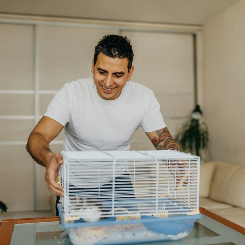 Man takes apart his hamster cage for cleaning