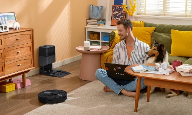 Roborock Q5+ robot vacuum with family pet cleaning the floor.