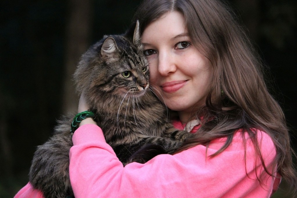 Woman holds cat in her arms